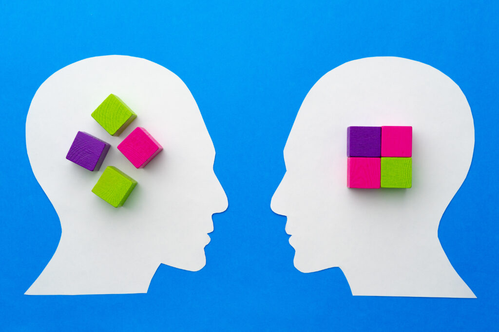 papercut silhouette of human head with colorful constructor pieces